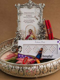 Invite prosperity, positivity, and spiritual grace with this exquisite German Silver Balaji Diya Tray Set. Thoughtfully crafted with intricate detailing, this divine set includes a Lord Venkateswara (Tirupati Balaji) idol, a traditional lotus diya, and an elegant decorative tray with an antique silver finish. German Silver pooja items are treasured for their timeless beauty and traditional appeal, making them a meaningful gift for special occasions. The sacred presence of Lord Balaji combined with the auspicious lotus diya symbolizes wealth, wisdom, and divine blessings, making this set a cherished addition to every home temple. This premium German Silver Gift Item is ideal for housewarming gifts, wedding return gifts, Satyanarayana pooja gifts, Varalakshmi Vratham gifts, festive gifting, and corporate spiritual gifts. Its elegant design and premium craftsmanship make it a memorable keepsake for guests, family, and loved ones.