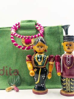 Handcrafted 7-inch Bride and Bridegroom Kondapalli wooden dolls with premium 8-inch green jute bag combo for traditional wedding return gifts.
