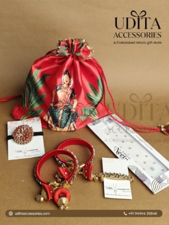 Half Saree ceremony return gift hamper with designer potli bag, silk thread bangles, bracelet, floral hair accessory, and bindi packet.