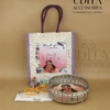 Premium Half Saree Ceremony return gift hamper with customized jute bag, decorative metal tray, silk thread bangles, lotus haldi kumkum, sweet supari packet, and bindi packet.