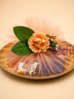Peacock brass plate hamper with blouse piece and haldi kumkum for housewarming return gifts and traditional festive gifting.