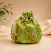 Premium green floral embroidered silk potli bag with pearl-beaded handle, decorative drawstring tassels, and gold bead detailing, ideal for weddings, bridal gifting, festive occasions, and return gifts.