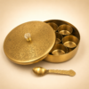 Premium brass masala box with 7 removable spice containers and engraved brass spoon for organizing Indian spices in traditional kitchens.