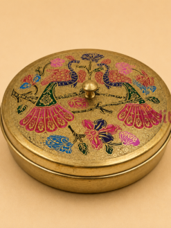 Decorative brass masala box with multicolor peacock artwork and 7 removable brass spice containers, ideal for spice storage, kitchen décor, housewarming gifts, wedding return gifts, and festive gifting.