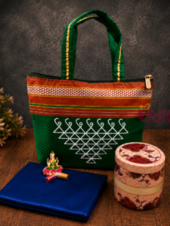 Kolam design fabric zipper bag with floral tin storage box, blouse piece, and Lakshmi haldi kumkum set for traditional return gifts.