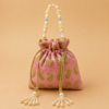 Premium pink designer potli bag with golden paisley embroidery, pearl handle, crystal bead accents, and pearl tassel drawstrings, ideal for weddings, bridal gifting, festive occasions, and return gifts.