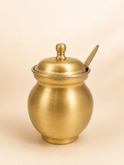 Premium brass ghee pot with lid and spoon for storing and serving ghee, ideal for pooja, kitchen use, and traditional return gifts.