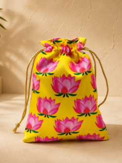Premium lotus print potli bag with floral design and drawstring closure, reusable return gift pouch for weddings, Varalakshmi Vratham, temple functions, festive gifting, and women, available in assorted colours.