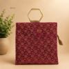 Premium floral jute bag with elegant gold metal handles, eco-friendly reusable return gift bag available in assorted colours and floral brocade designs for weddings, festivals, housewarming, and corporate gifting.