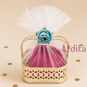 Housewarming return gift hamper with 5-inch Pichwai metal tray, brocade blouse piece, and pair of glass bangles.